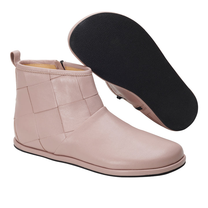 Die SQARLETT Nude Stiefelette in Beige von ZAQQ besticht durch ein schickes Struktur- und Steppmuster. Die stylischen Boots sind mit einem praktischen seitlichen Reißverschluss ausgestattet und werden durch eine schwarze Gummisohle ergänzt. Ein Stiefel steht aufrecht, während der andere die Sohle nach oben zeigt, was das modische Design unterstreicht.